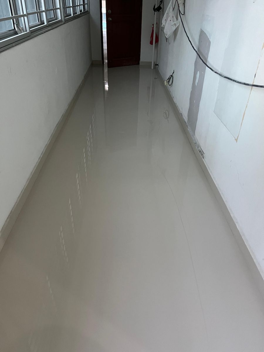Marble gum grouting on homogeneous tiles in HDB corridor with seamless glossy finish
