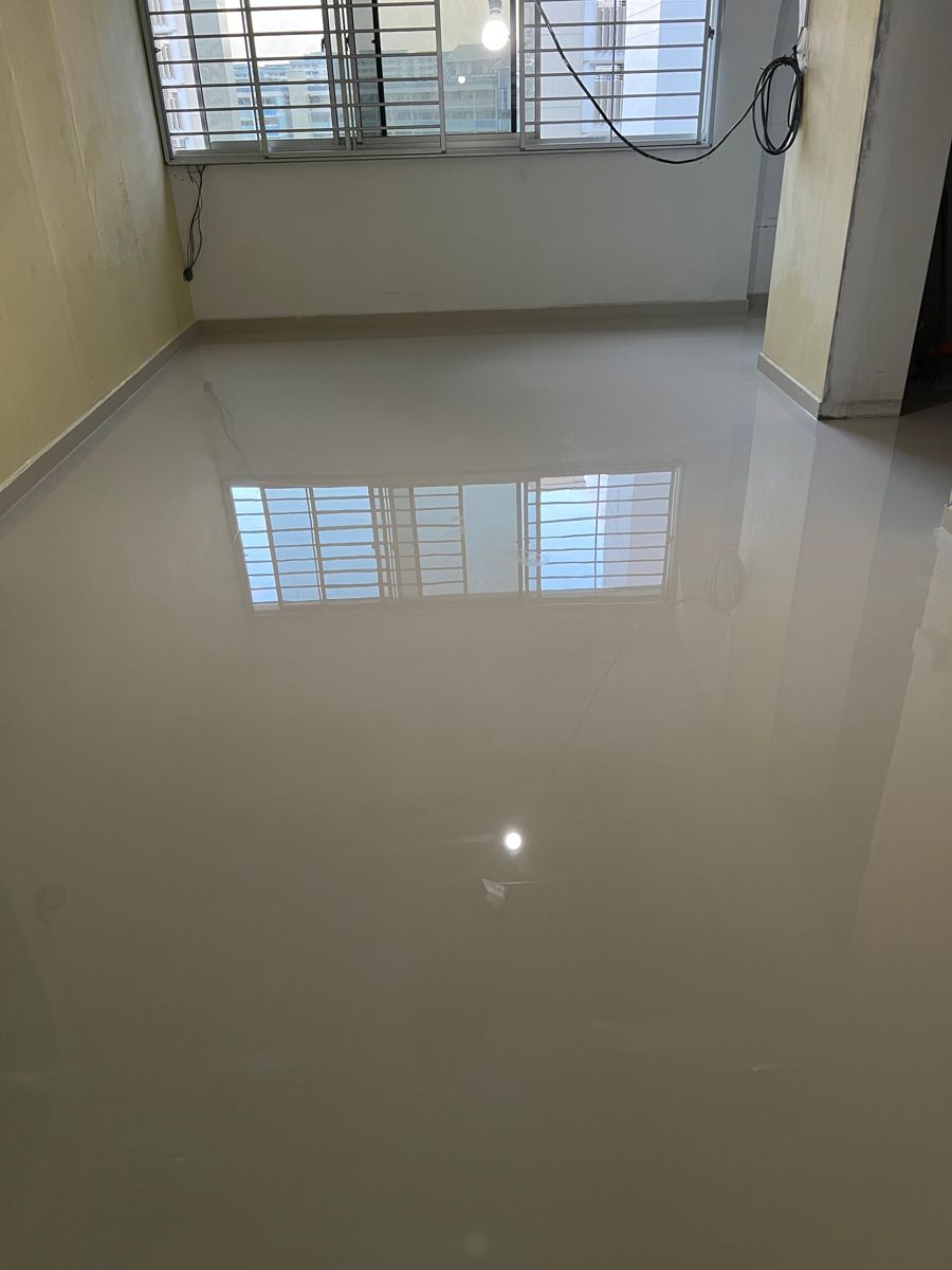 Polished homogeneous tiles in HDB living room reflecting window light